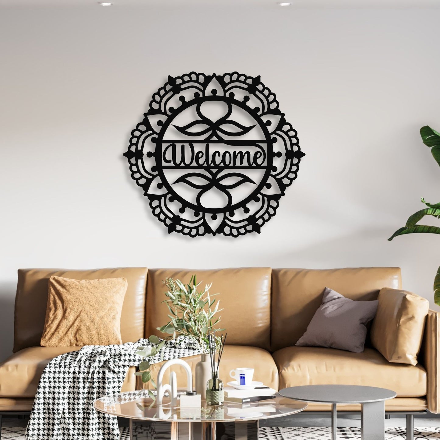 Decorative wall art with 'Welcome' on a living room wall above a brown sofa.