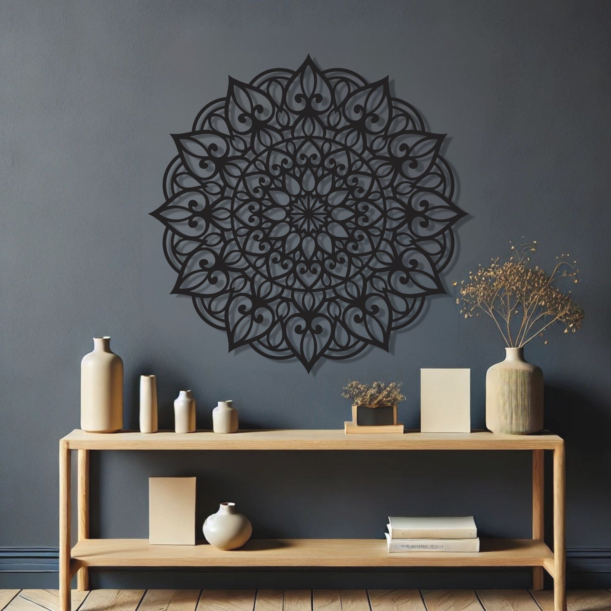 Decorative wall mandala on a dark gray wall with a wooden console table and decorative items.
