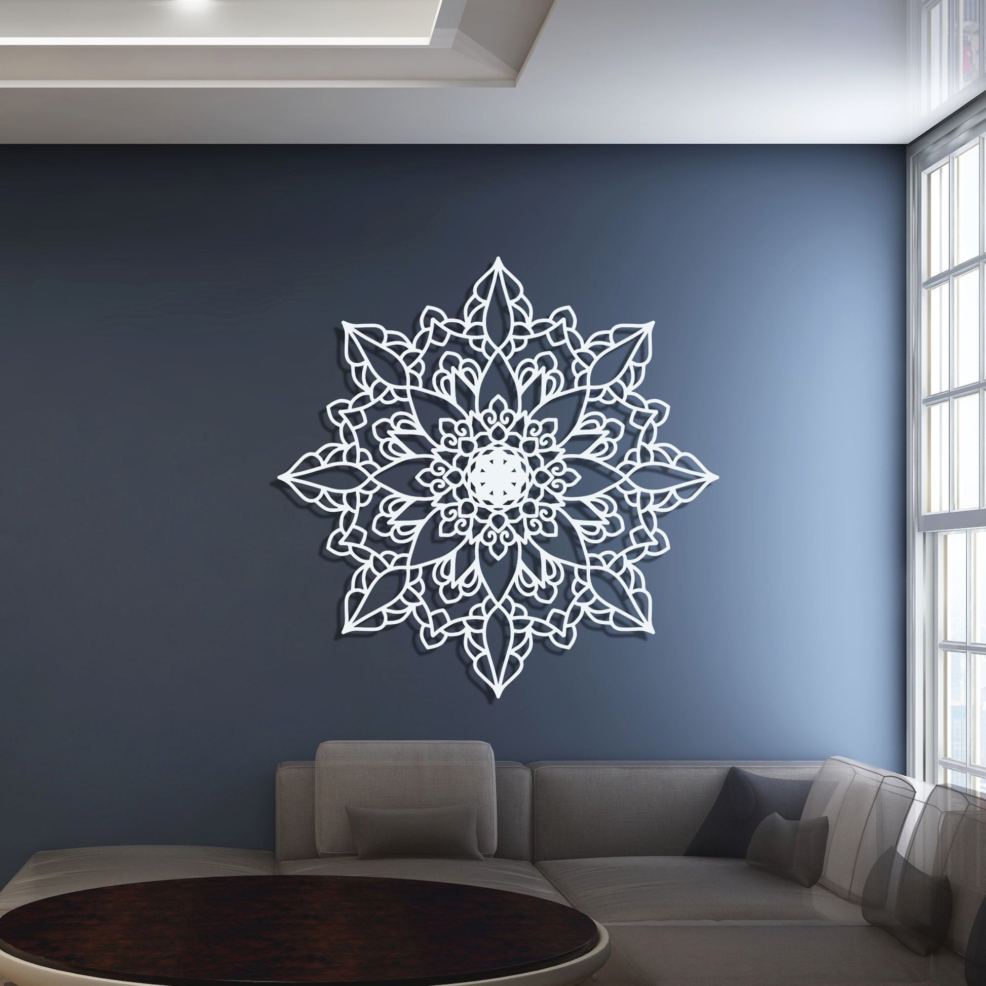 Decorative wall mandala on a blue wall in a living room.