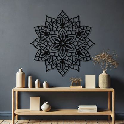 Decorative black mandala wall art on a gray wall with a wooden console table and decorative items.