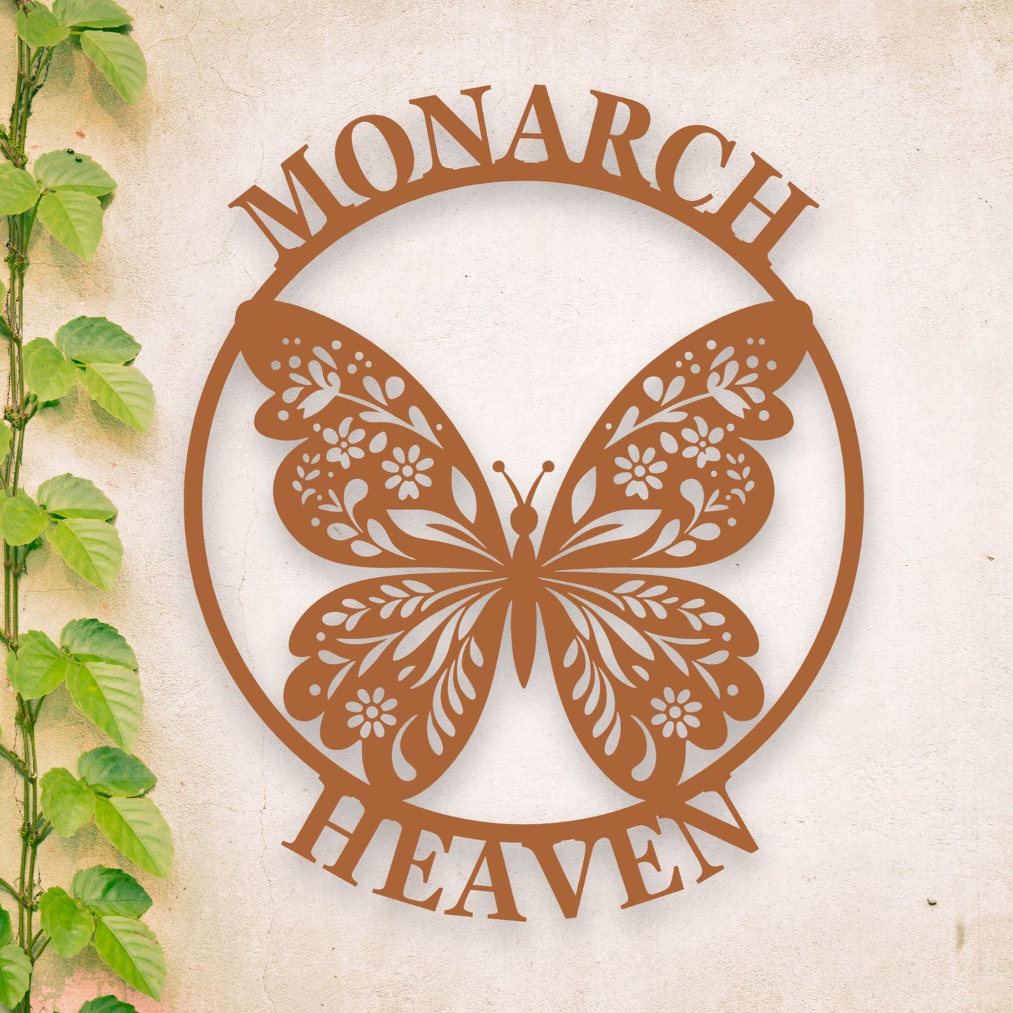 Decorative metal butterfly with 'Monarch Heaven' text on a textured background