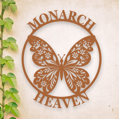 Decorative metal butterfly with 'Monarch Heaven' text on a textured background