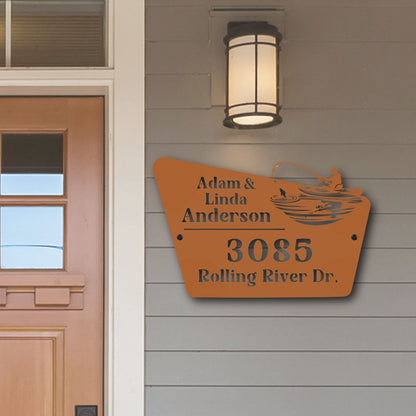 House exterior with a personalized address sign on a gray wall.
