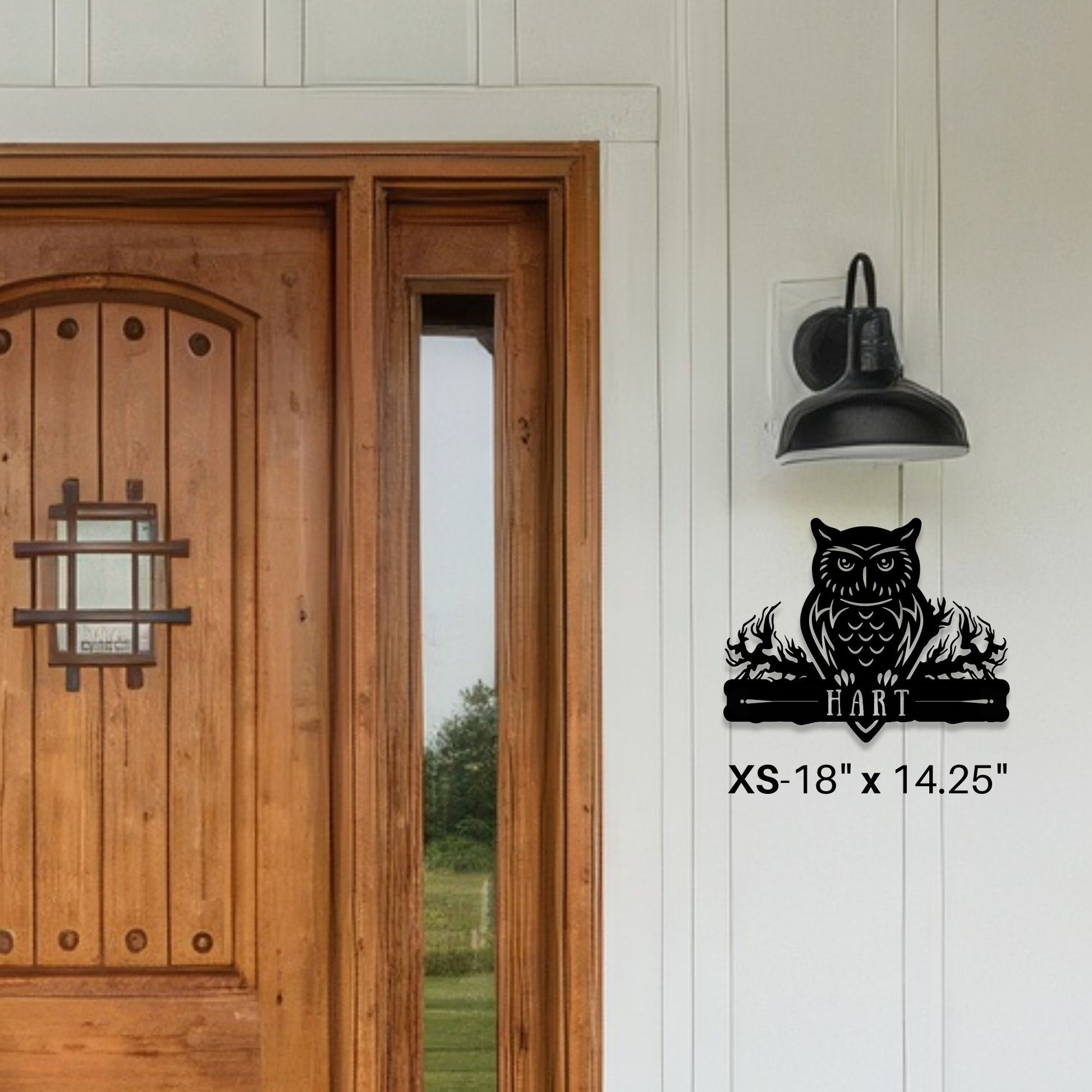 Wooden door with a decorative owl wall decal on a white wall.