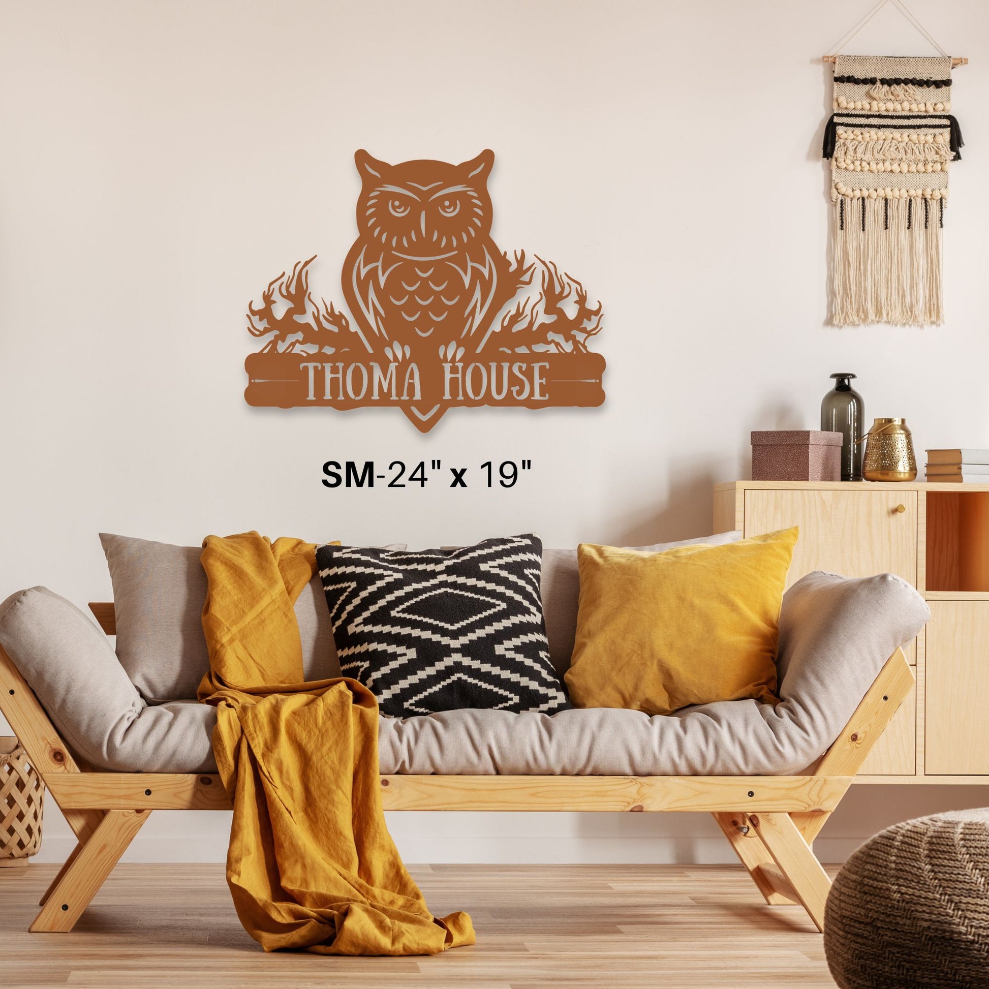 Wooden owl wall decor with 'THOMA HOUSE' text in a living room setting.