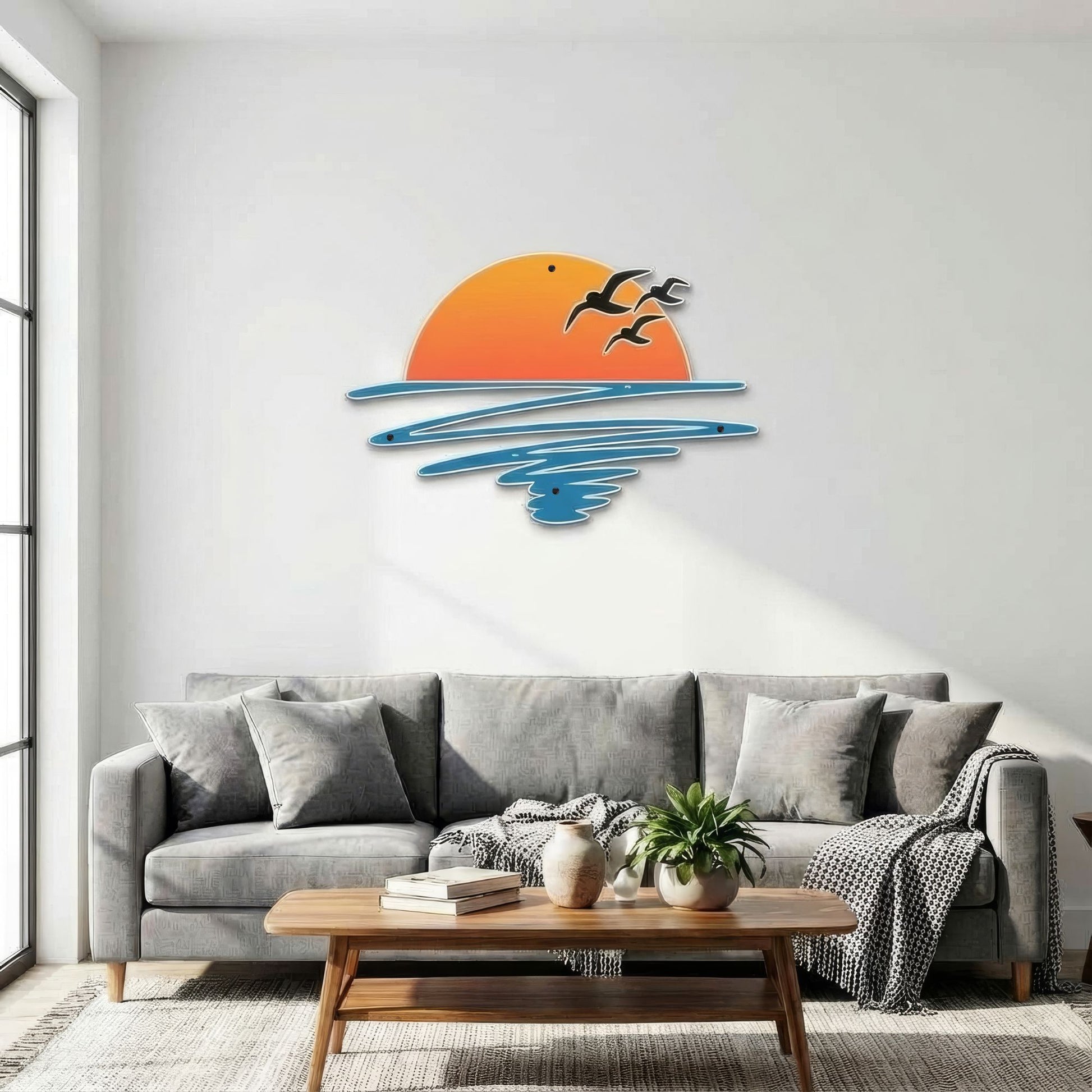 Living room with a gray sofa, wooden coffee table, and decorative wall art of a sunset with birds.