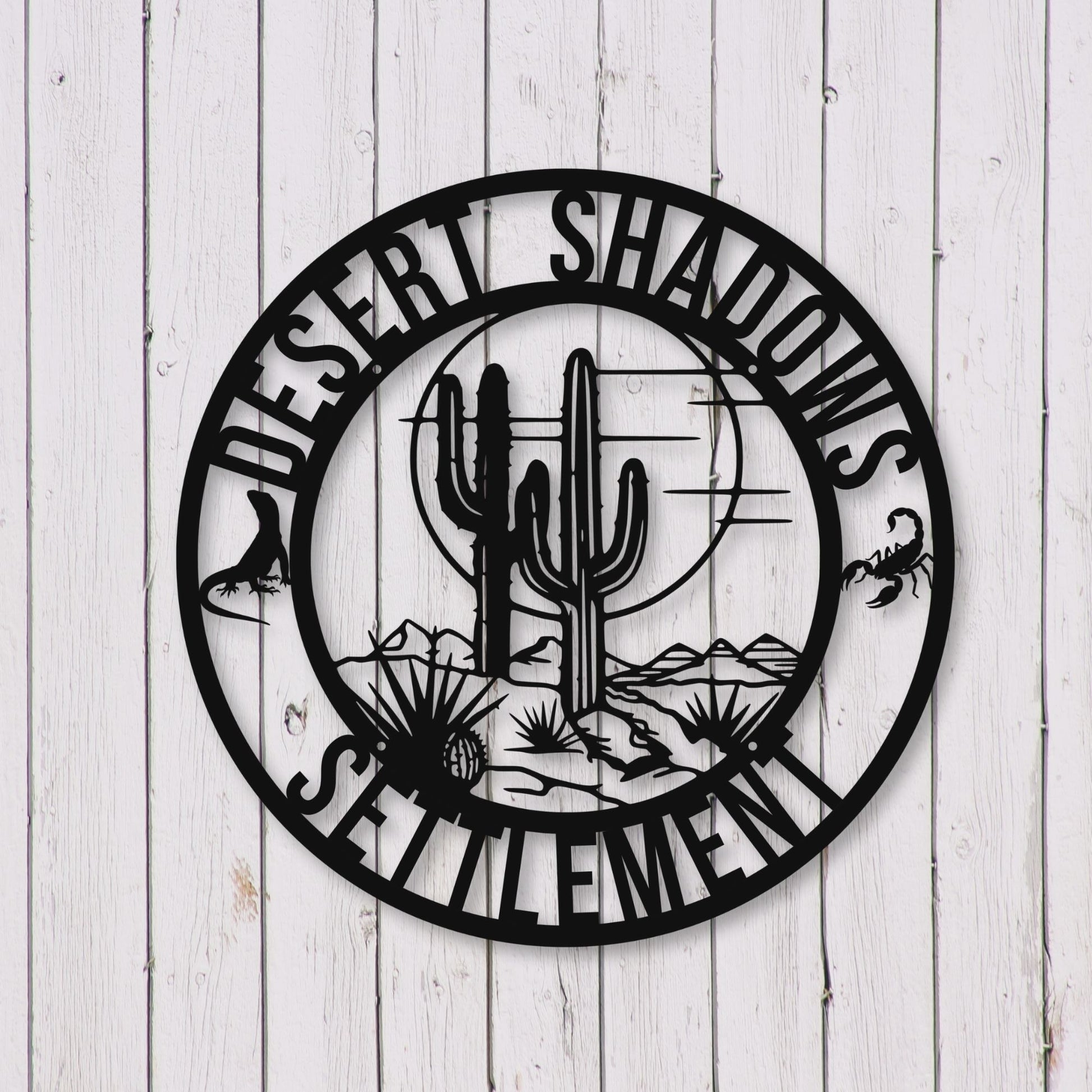 Decorative wall art with cactus design and 'Desert Shadows Settlement' text on a wooden background