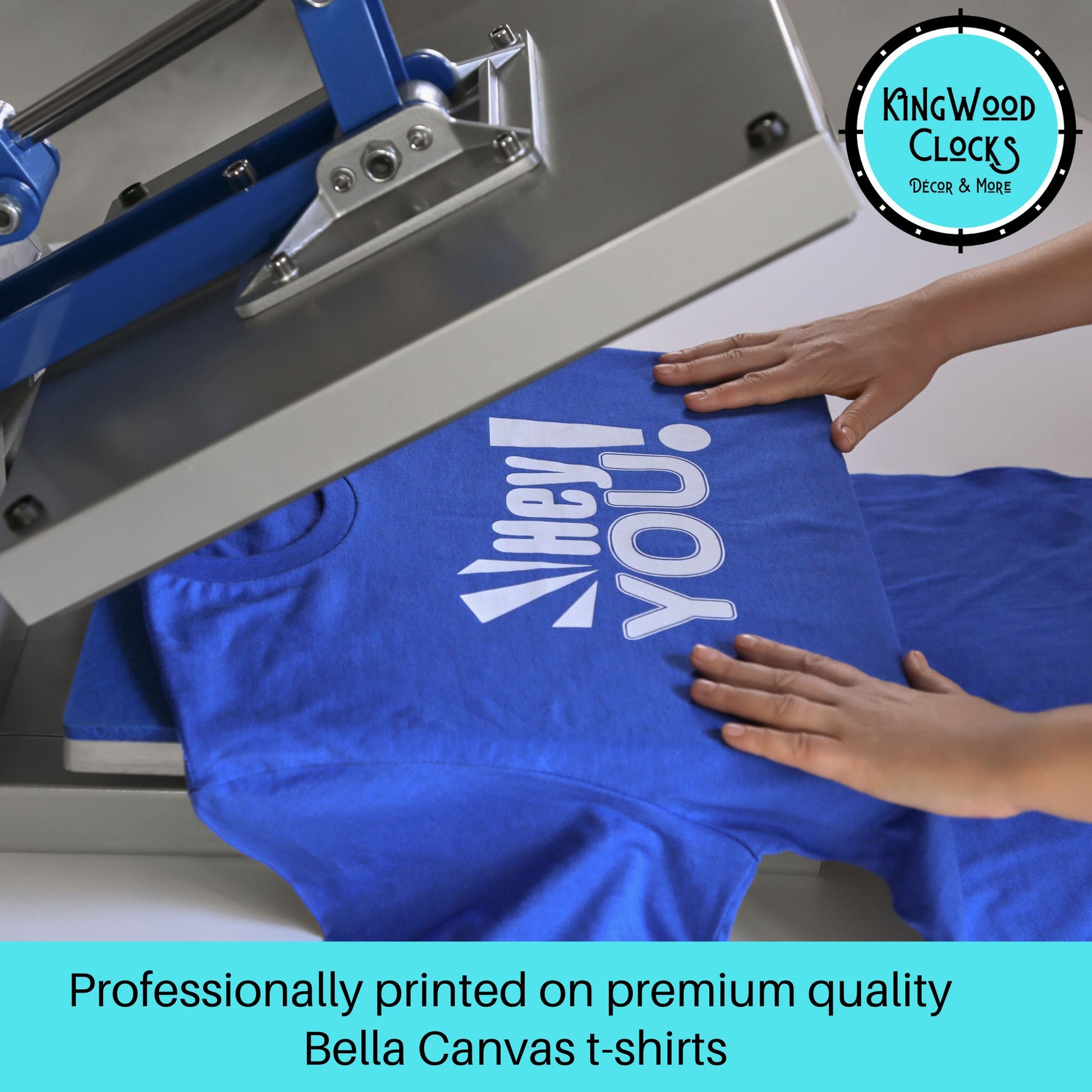 Blue t-shirt with white text being printed on a screen printing machine, with 'Kingwood Clocks' logo in the corner.