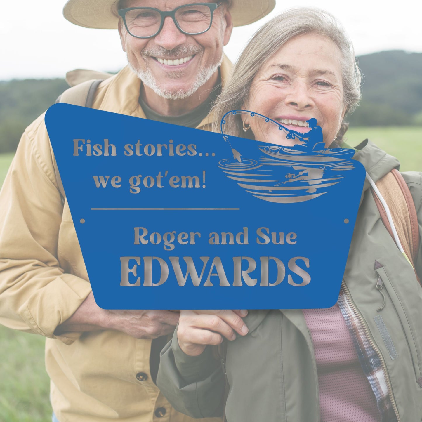 Two people holding a blue sign with text and a fish illustration, standing outdoors.