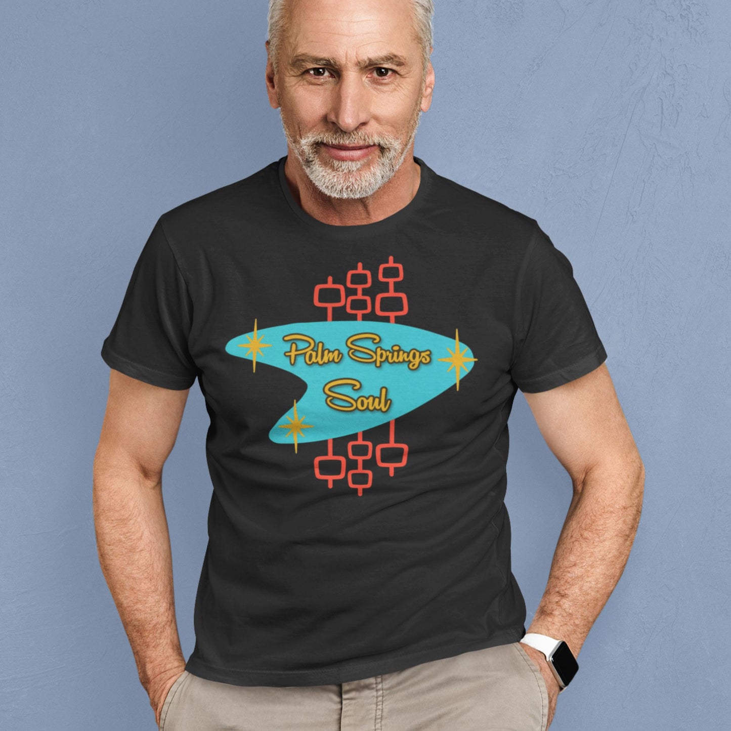 Man wearing a black t-shirt with 'Palm Springs Soul' design against a blue background