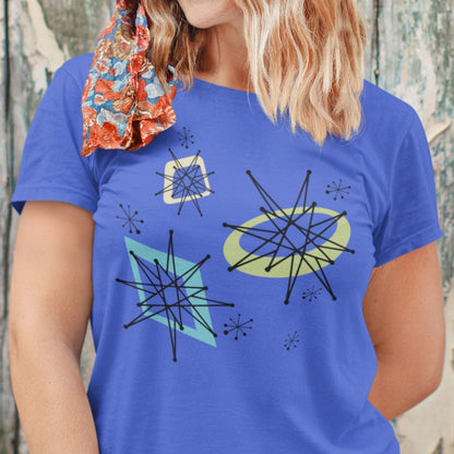Woman wearing a blue t-shirt with abstract designs against a wooden background