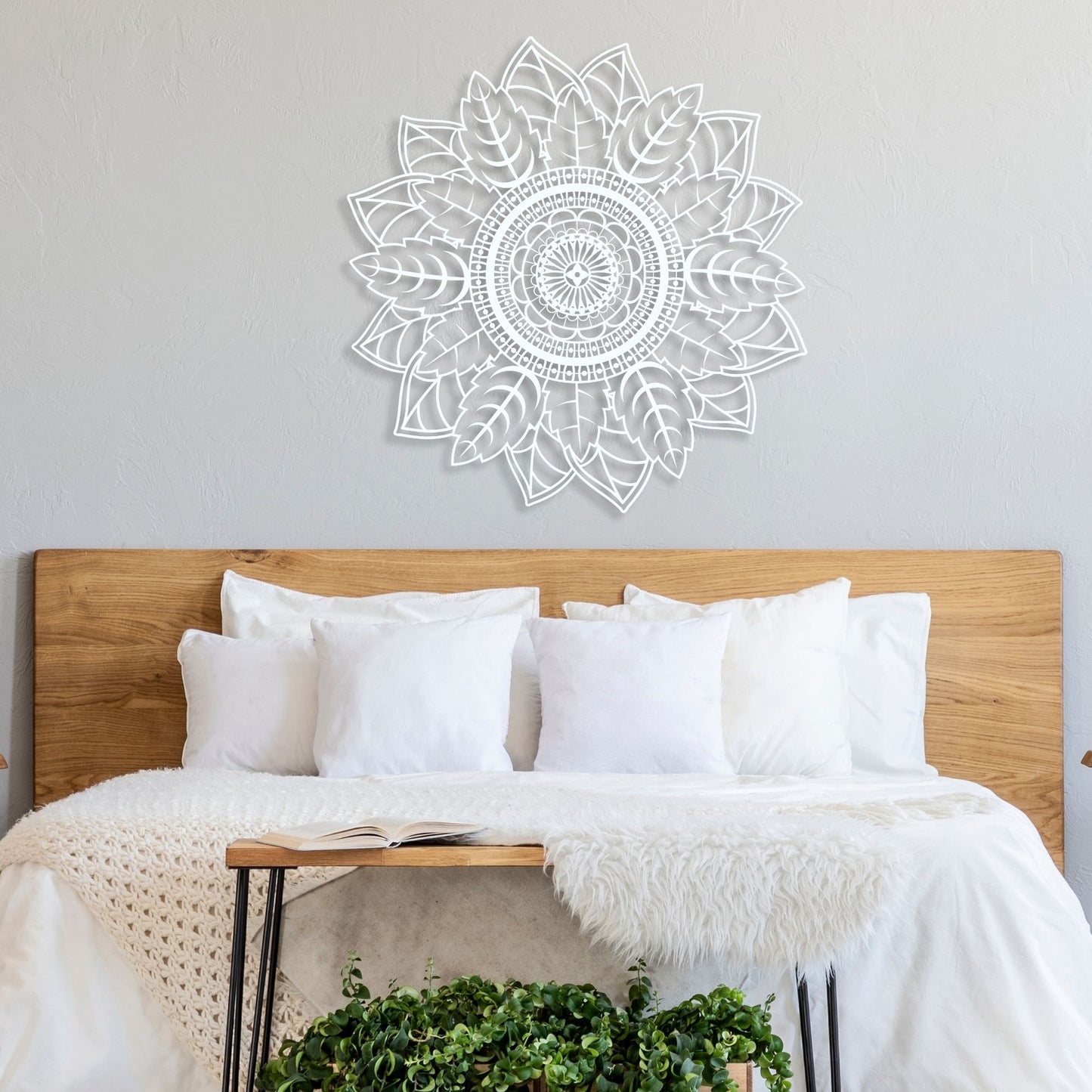 Mandala wall decal above a bed with white bedding and wooden headboard.