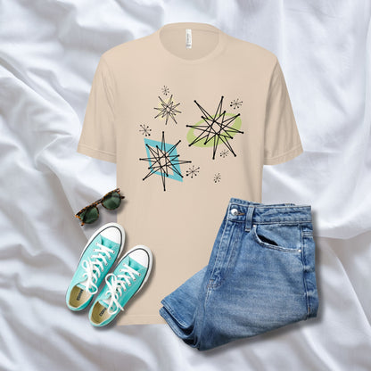 Beige t-shirt with geometric designs, blue jeans, and turquoise sneakers on a white background