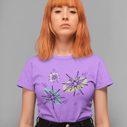 Person wearing a purple t-shirt with geometric designs on a gray background