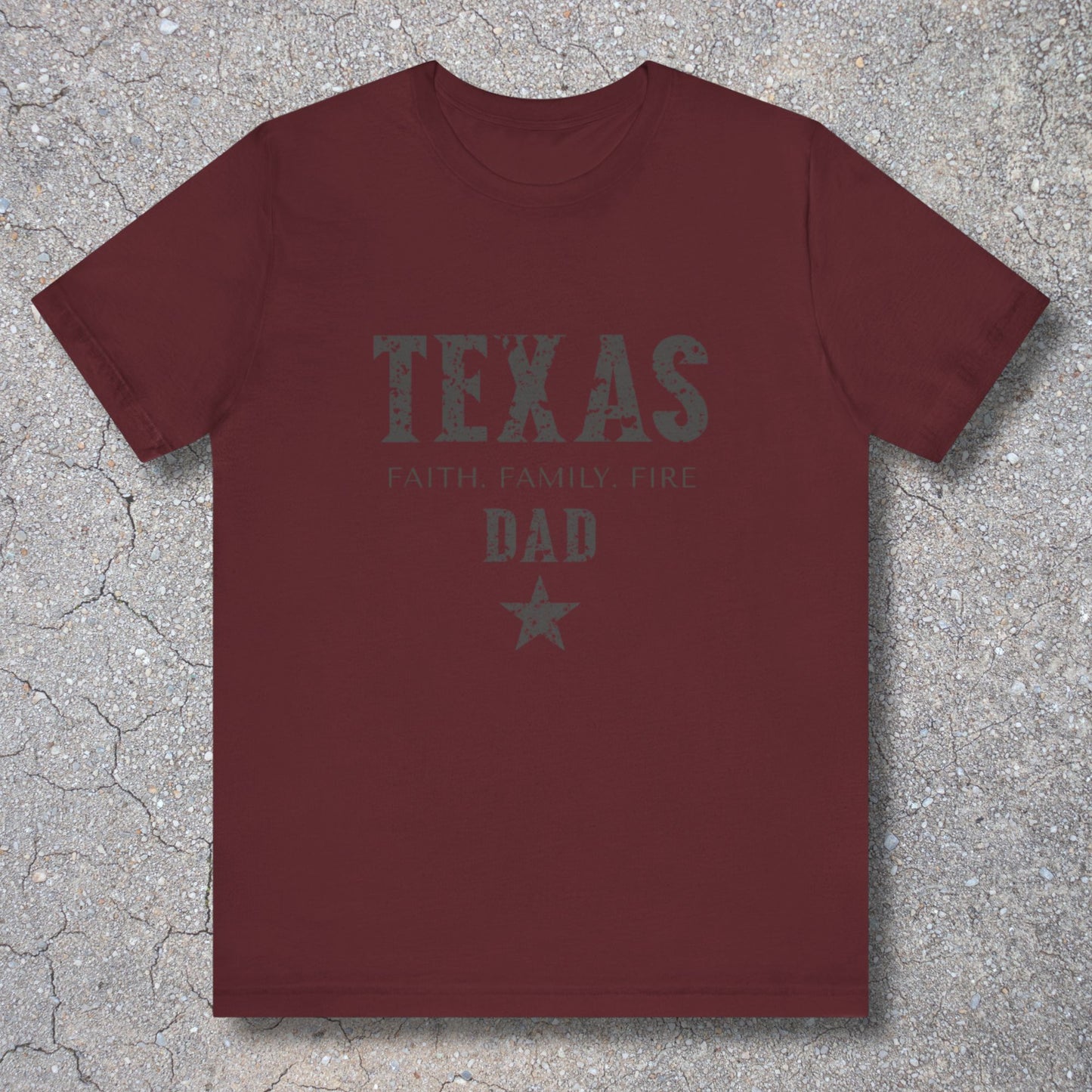 Maroon t-shirt with 'TEXAS FAMILY FIRE DAD' text on a textured surface