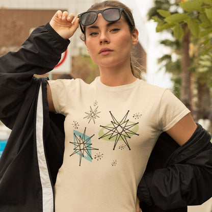 Woman wearing a beige t-shirt with geometric star designs outdoors