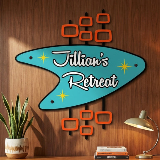 Decorative sign with 'Jillian's Retreat' on a wooden wall, next to a plant and lamp.